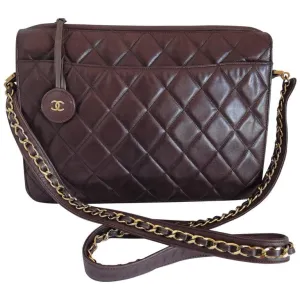 80's vintage Chanel dark brown quilted lambskin shoulder bag with CC motif and built-in chain shoulder strap. Rare Chanel purse