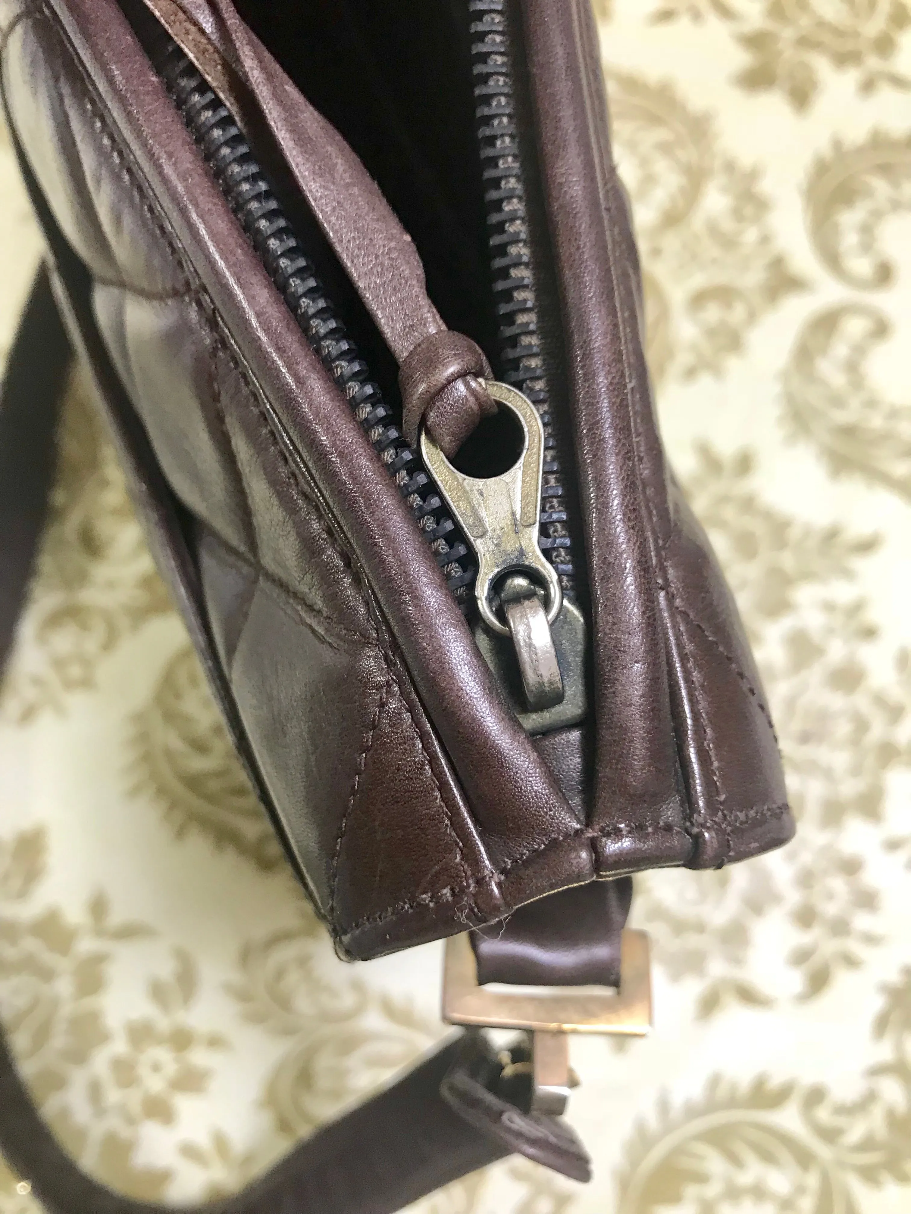 80's vintage Chanel dark brown quilted lambskin shoulder bag with CC motif and built-in chain shoulder strap. Rare Chanel purse