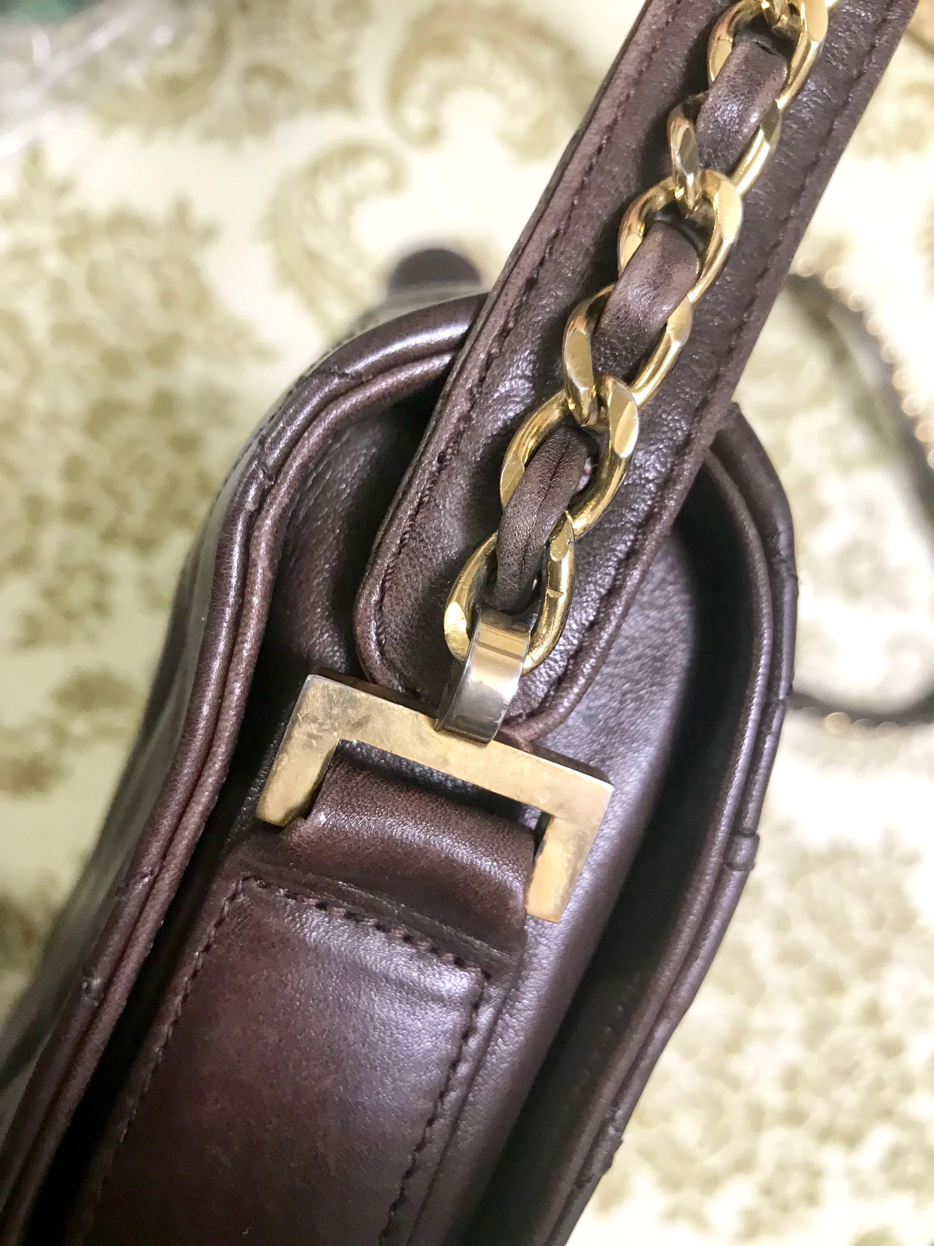 80's vintage Chanel dark brown quilted lambskin shoulder bag with CC motif and built-in chain shoulder strap. Rare Chanel purse