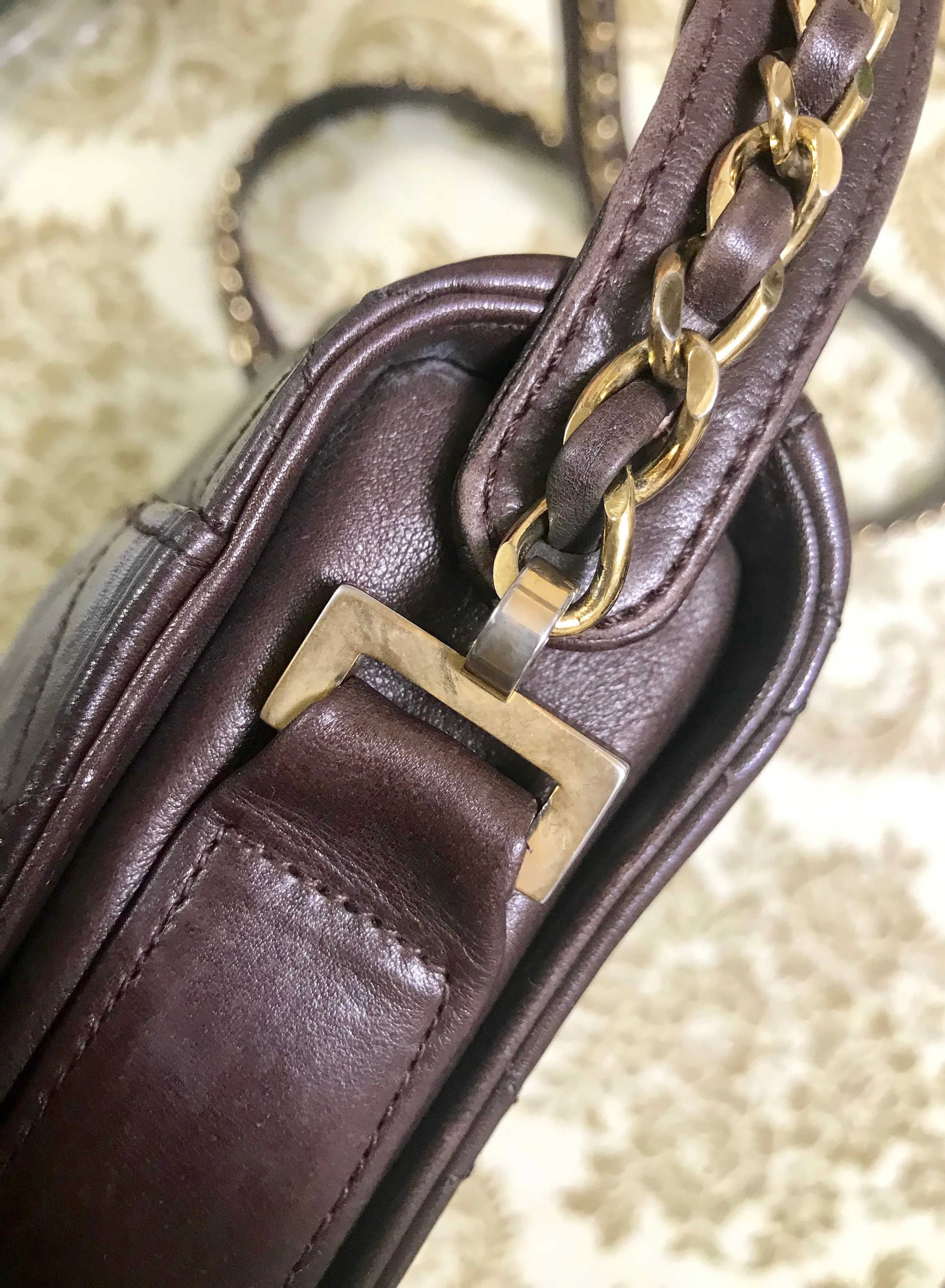 80's vintage Chanel dark brown quilted lambskin shoulder bag with CC motif and built-in chain shoulder strap. Rare Chanel purse