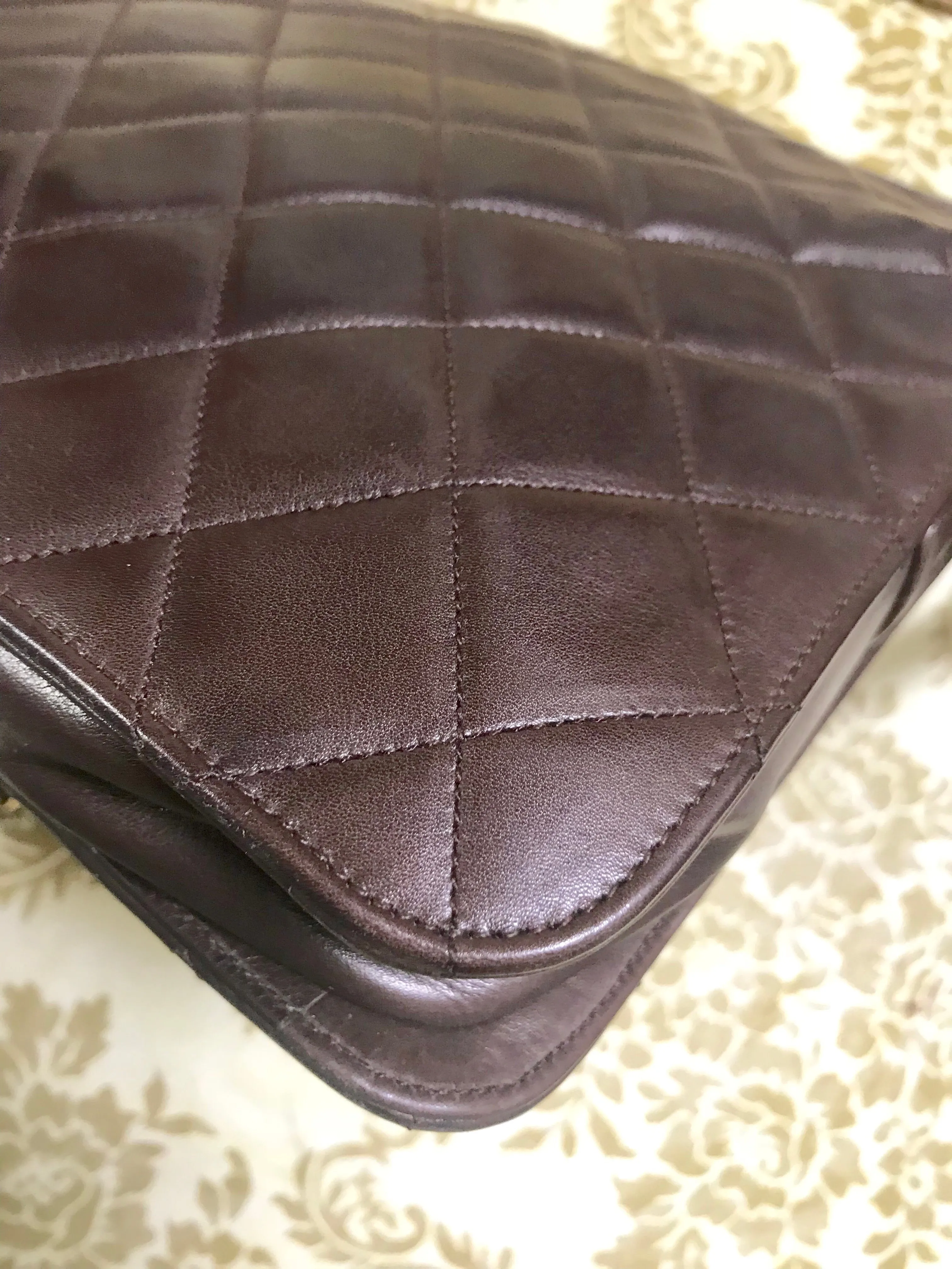 80's vintage Chanel dark brown quilted lambskin shoulder bag with CC motif and built-in chain shoulder strap. Rare Chanel purse
