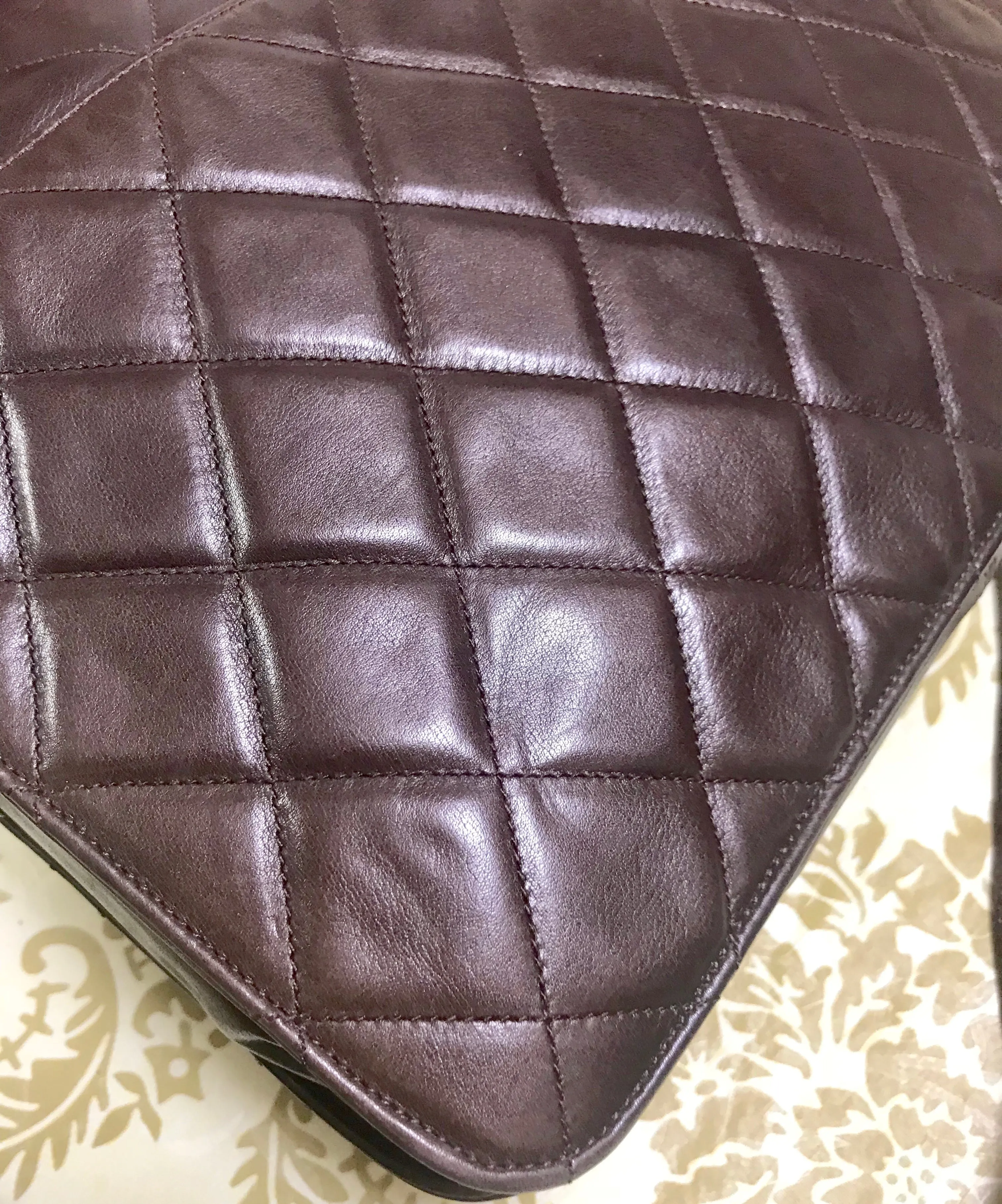 80's vintage Chanel dark brown quilted lambskin shoulder bag with CC motif and built-in chain shoulder strap. Rare Chanel purse
