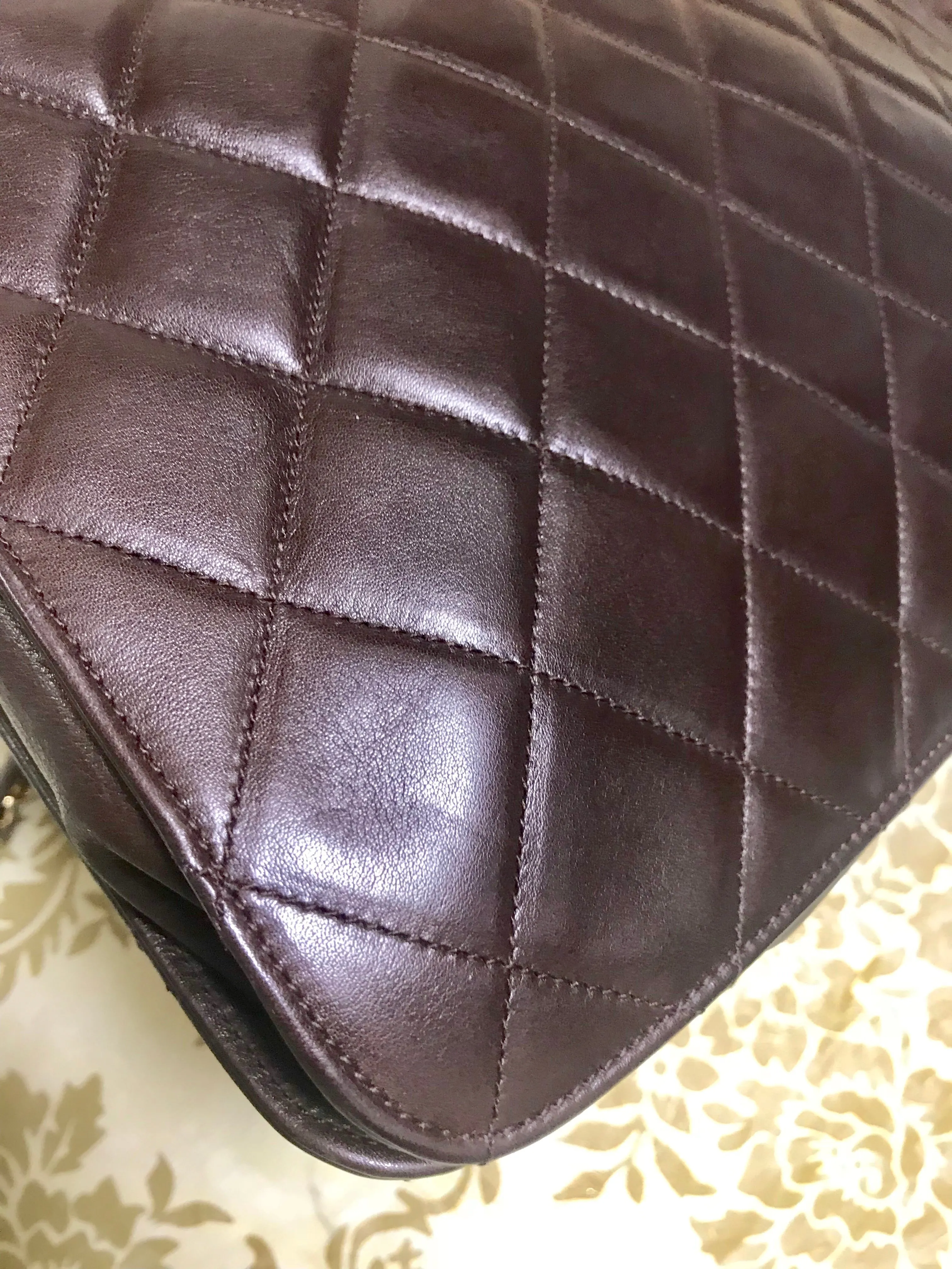 80's vintage Chanel dark brown quilted lambskin shoulder bag with CC motif and built-in chain shoulder strap. Rare Chanel purse