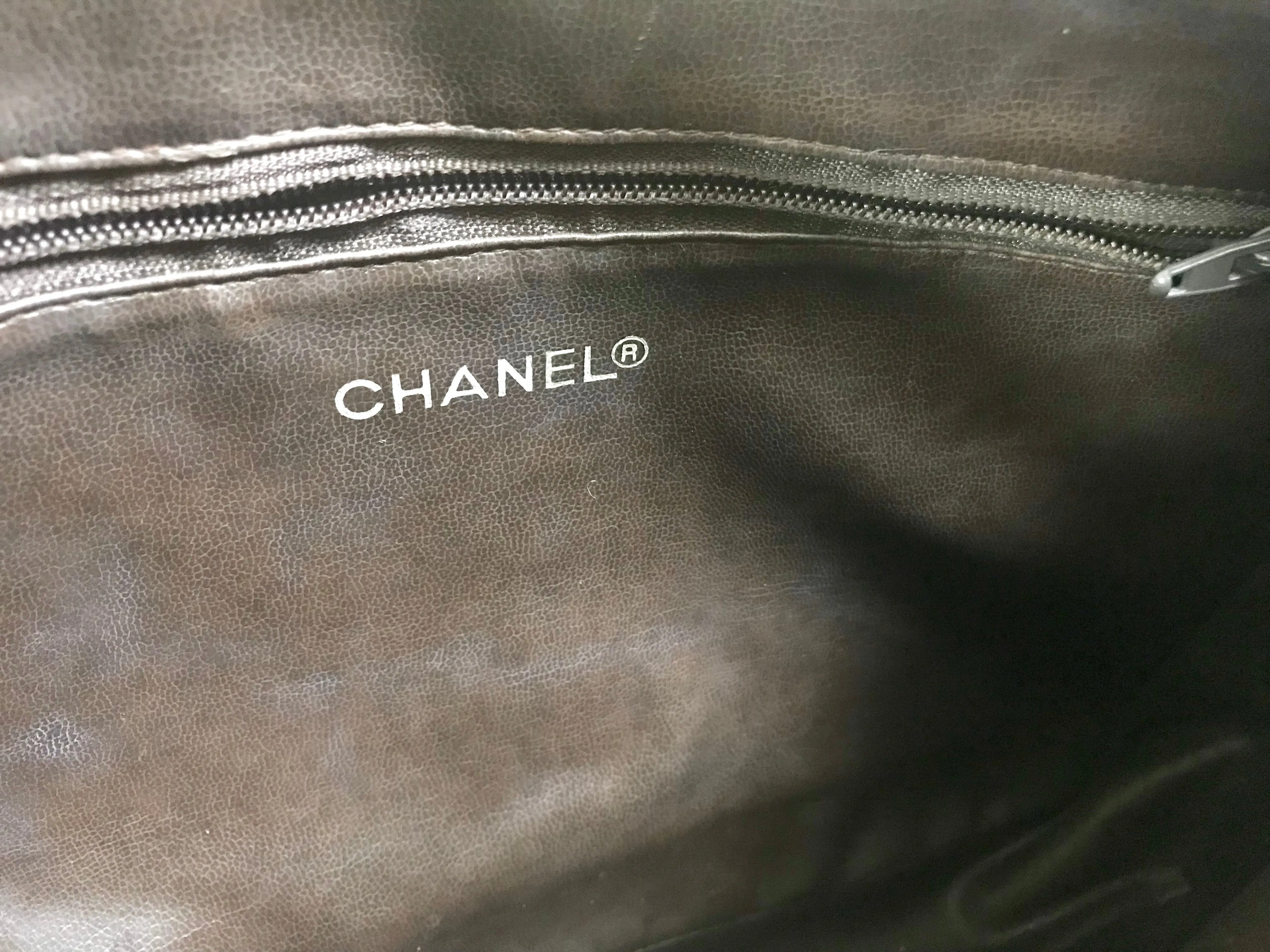80's vintage Chanel dark brown quilted lambskin shoulder bag with CC motif and built-in chain shoulder strap. Rare Chanel purse