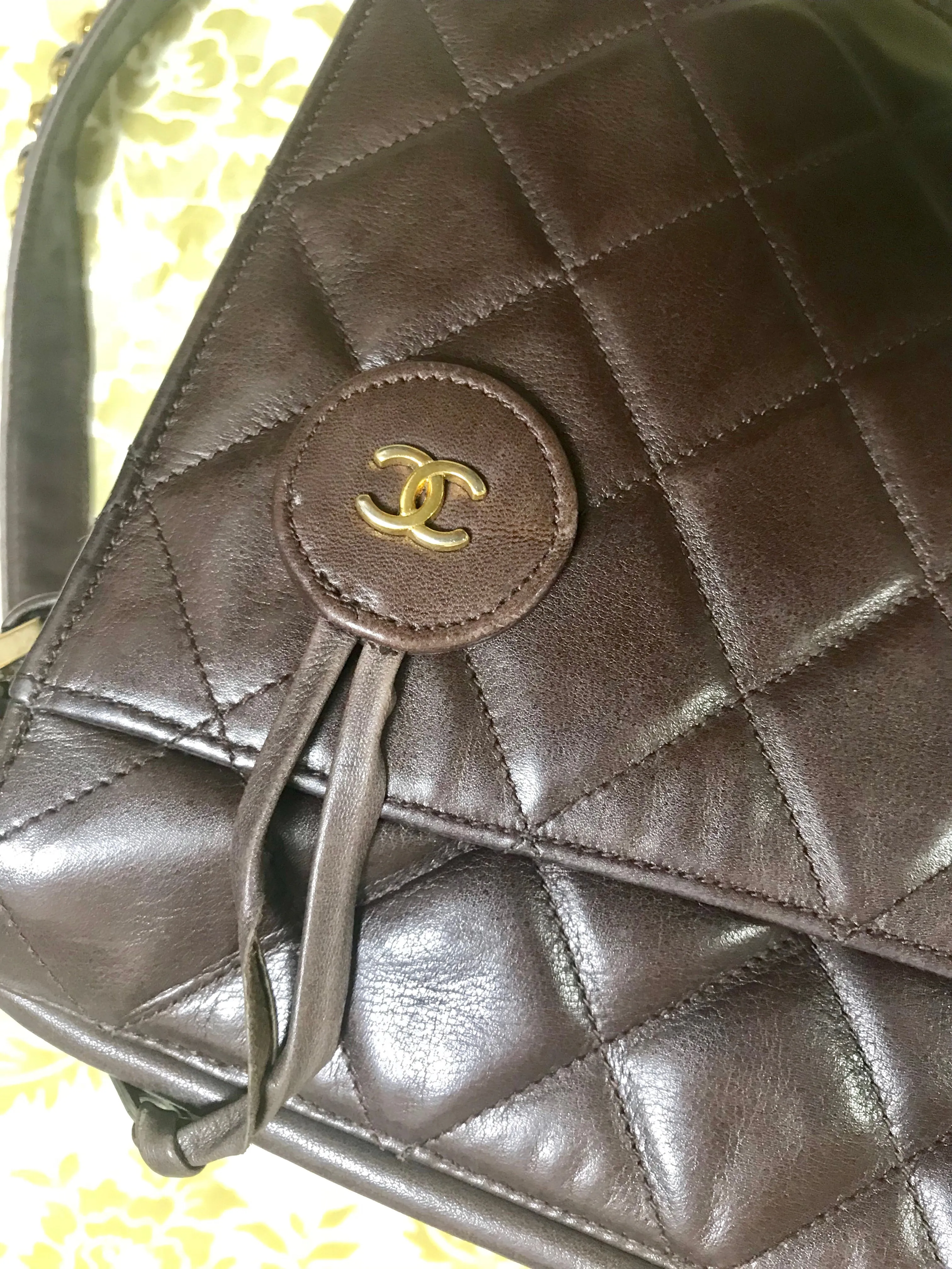 80's vintage Chanel dark brown quilted lambskin shoulder bag with CC motif and built-in chain shoulder strap. Rare Chanel purse