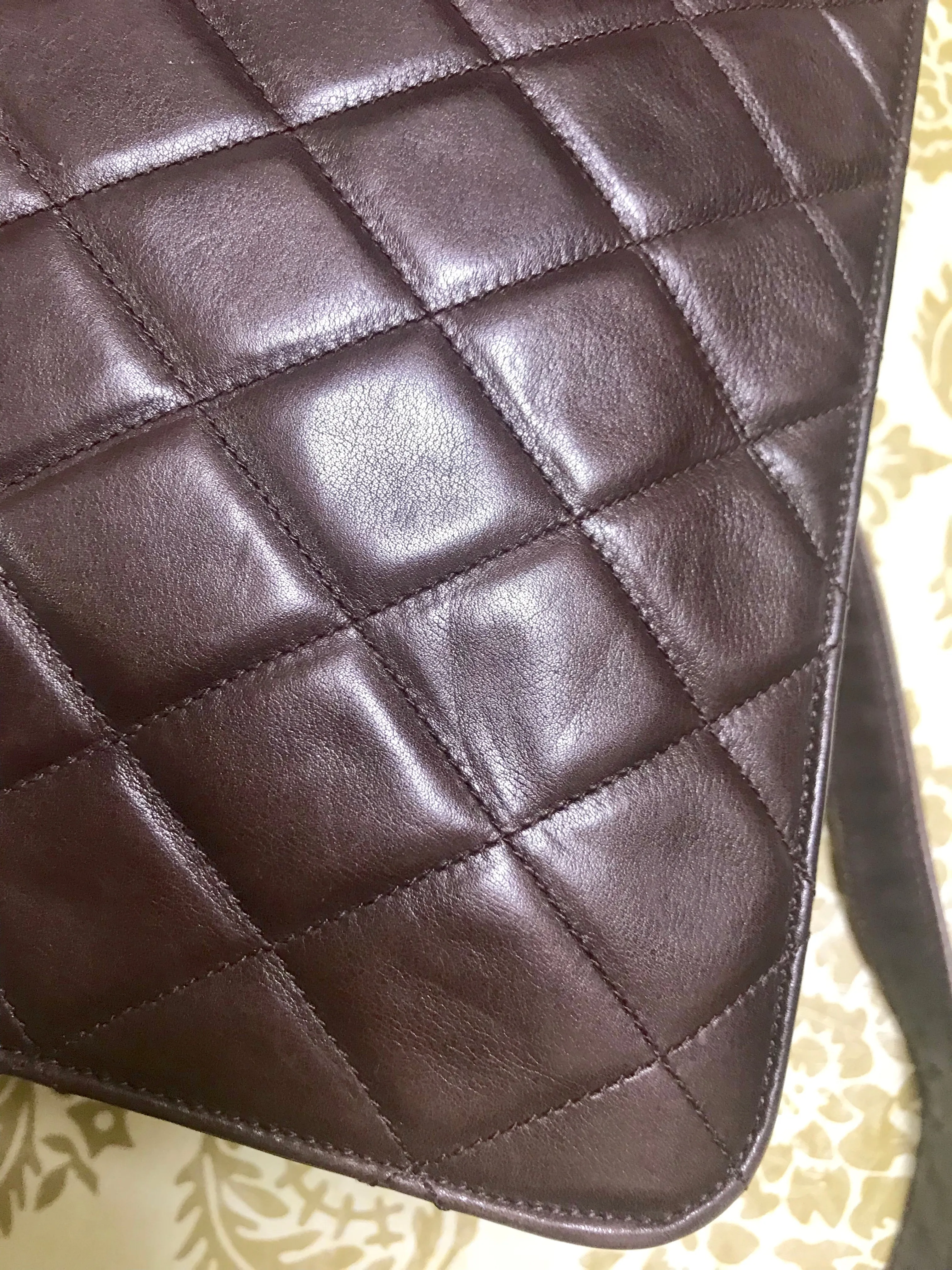 80's vintage Chanel dark brown quilted lambskin shoulder bag with CC motif and built-in chain shoulder strap. Rare Chanel purse